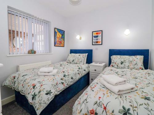 a bedroom with two beds and a window at Southview Bungalow in Barmston