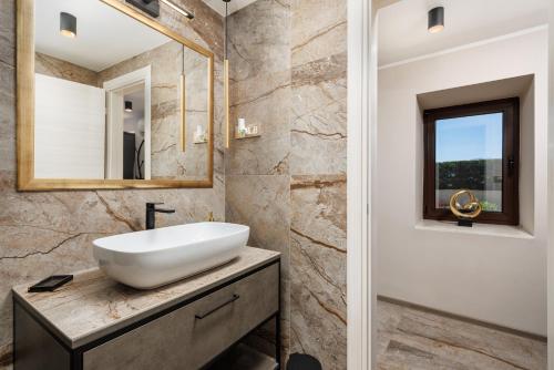 a bathroom with a sink and a mirror at SROK luxury apartments by the pool in Kastav