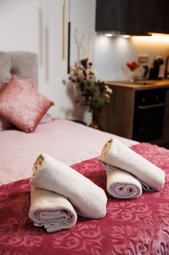 two towels sitting on top of a bed at SROK luxury apartments by the pool in Kastav