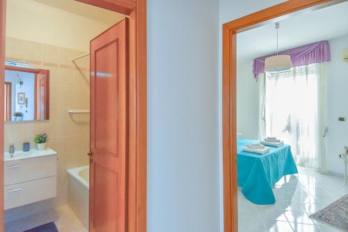 a bathroom with a table and a room with a tub at Dimora La Cupa in Monteroni di Lecce