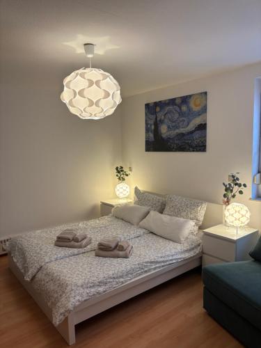 a bedroom with a bed and a chandelier at Blick auf Bautzen in Doberschau