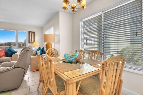 a dining room with a table and chairs at #7 Ocean Court by Oak Island Accommodations in Caswell Beach