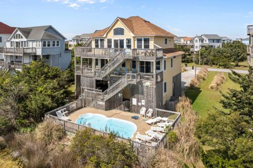 an aerial view of a large house with a swimming pool at 7680 - Sandy Bottom in Avon