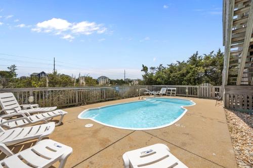 a patio with chairs and a swimming pool at 7680 - Sandy Bottom in Avon