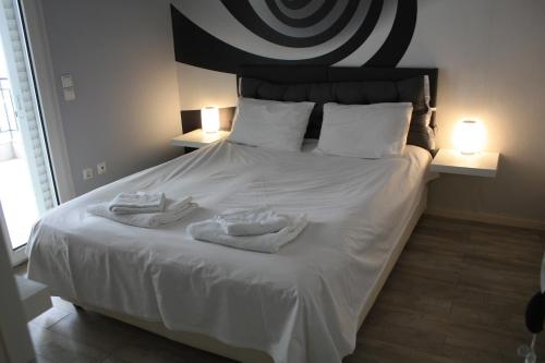 a bedroom with a bed with towels on it at Despina's apts in Kalamariá