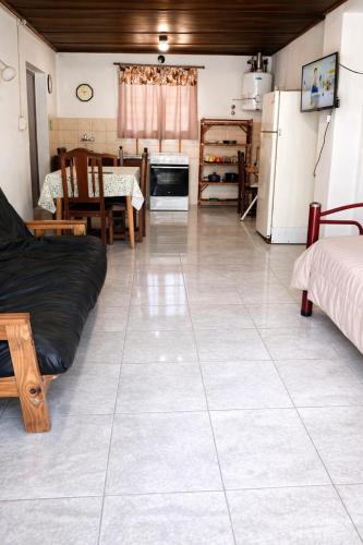 a kitchen and living room with a large tile floor at Hospedaje Don Felix in General Acha