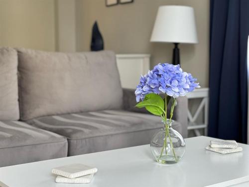 a vase with blue flowers sitting on a table at 3315-Magic StudioCondo near Universal in Orlando