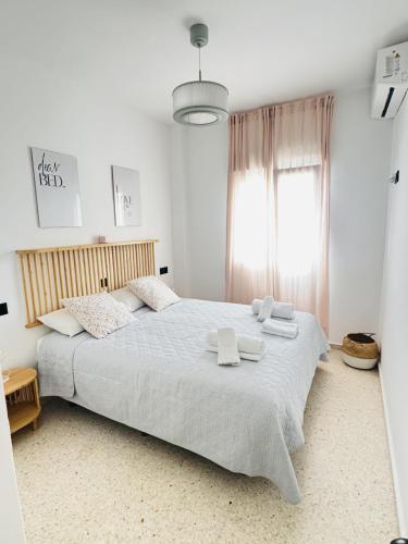 a bedroom with a large bed with two towels on it at Sala 8 Gran Cinema in Sanlúcar de Barrameda