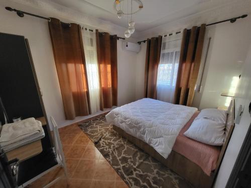 a bedroom with a bed and a television in it at Errachidia Airport Apartment AC 15 Min Walk to Airport Gateway to Merzouga in Oulad el Haj