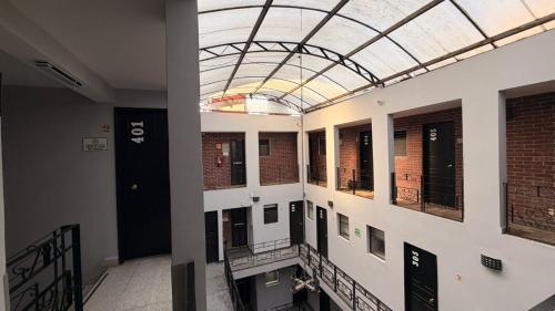 a hallway in a building with a glass ceiling at Hotel Florida, Centro Histórico in Mexico City