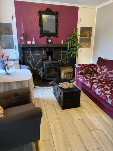 a living room with a couch and a fireplace at Kings Accommodation in Donegal