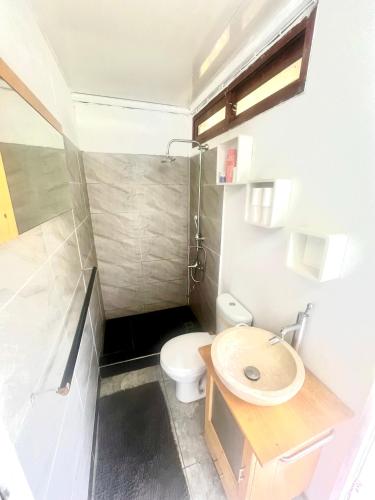 a small bathroom with a toilet and a sink at Ritualodge in Bora Bora