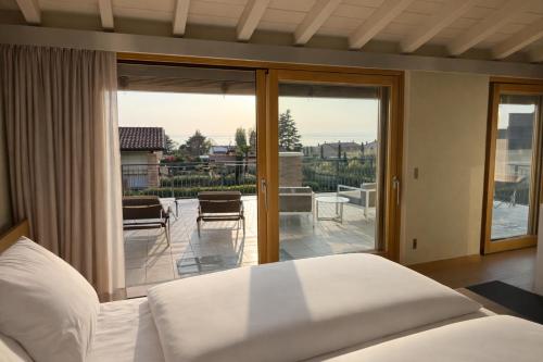 a bedroom with a bed and a sliding glass door at Pool Villa Lazise in Lazise