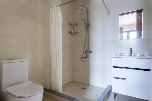 a bathroom with a shower and a toilet and a sink at Olchazor hotel in Tashkent
