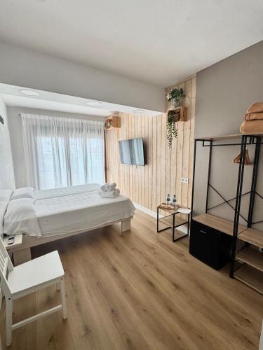 a bedroom with a large bed and a window at Valbanera in Colombres