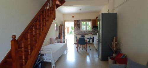 a living room with a staircase and a kitchen at Galini in Mytikas