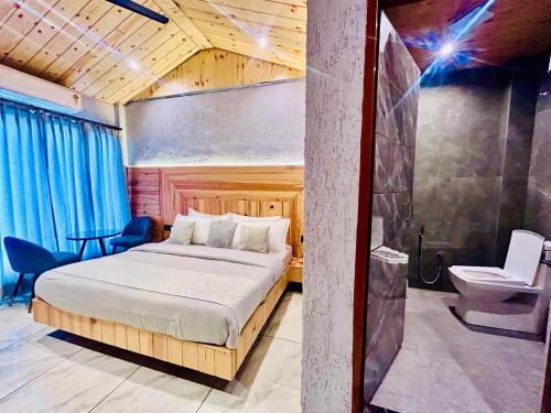 a bedroom with a bed and a toilet in a room at Living On The Edge A Luxury Stay in Mussoorie in Mussoorie