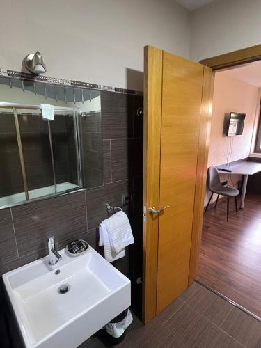 a bathroom with a sink and a mirror at La Sabelona in Otero de Sanabria