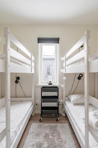 two bunk beds in a room with a window at Kungsberget Ski apartment 31C in Järbo