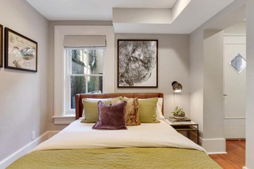 a bedroom with a large bed and a window at Cozy Charming Historic Home in Savannah
