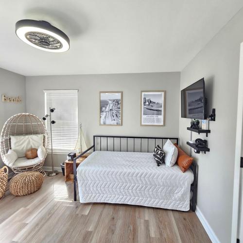 a bedroom with a bed and a chair at Atlantic City Bungalow Retreat in Atlantic City