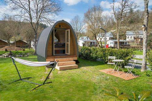 a small tent with a hammock in a yard at Pod View-side river am clerve in Enscherange
