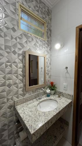 a bathroom with a sink and a mirror at Recanto 3ELLL in Bodoquena