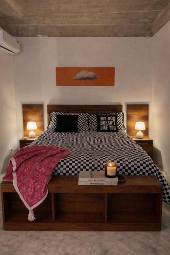 a bedroom with a large bed with a wooden table at Casa Once in Las Terrenas