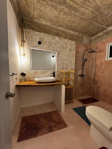 a bathroom with a toilet and a sink and a shower at Casa Once in Las Terrenas