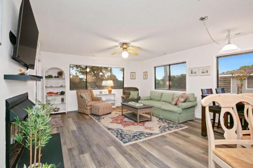 a living room with a couch and a table at 36 Bunker Court by Oak Island Accommodations in Caswell Beach