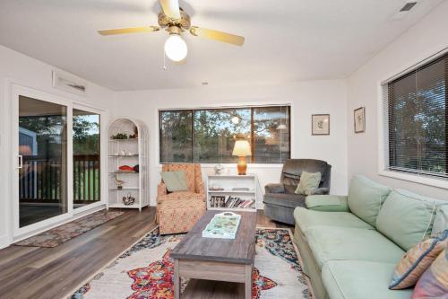 a living room with a couch and a ceiling fan at 36 Bunker Court by Oak Island Accommodations in Caswell Beach