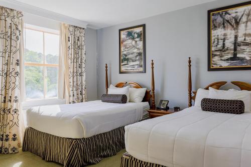 two beds in a room with a window at Arlington Resort Hotel & Spa in Hot Springs