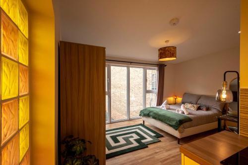 a living room with a couch and a large window at Paradise Retreat in Cambridge