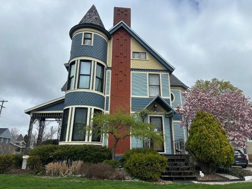 a large house with a chimney on top of it at The Fresh Coast Inn at Ludington in Ludington