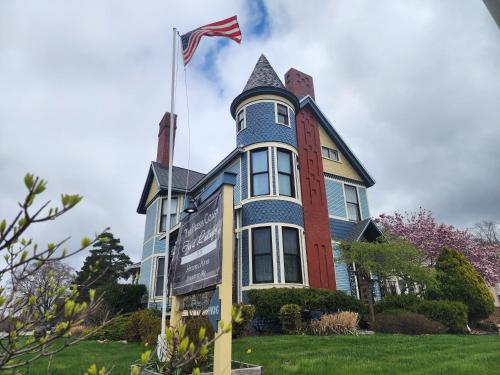 a house with an american flag on top of it at The Fresh Coast Inn at Ludington in Ludington