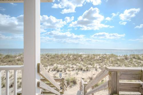 a view of the beach from the porch of a beach house at 7th Heaven by Oak Island Accommodations in Oak Island