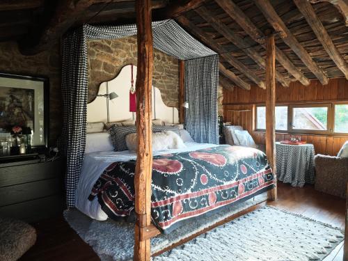 a bedroom with a canopy bed and a table at Casa Tejada in Rúerrero