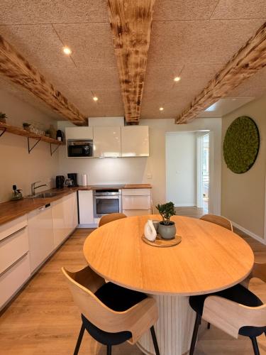 a kitchen with a wooden table and chairs at Hygge Green Retreat Billund 102 in Give