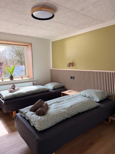 two beds with teddy bears on them in a room at Hygge Green Retreat Billund 102 in Give