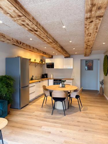 a kitchen and dining room with a table and chairs at Hygge Green Retreat Billund 102 in Give