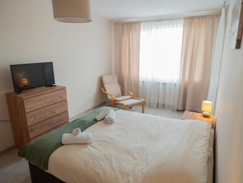 a bedroom with a bed with two towels on it at Active Homes in Veliko Tŭrnovo