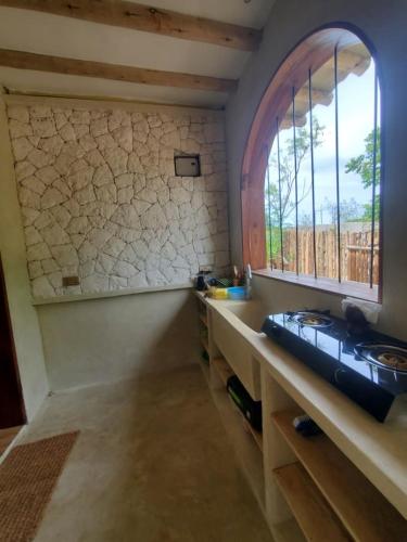 a kitchen with a sink and a window at Hakuna Marika in Umbuji