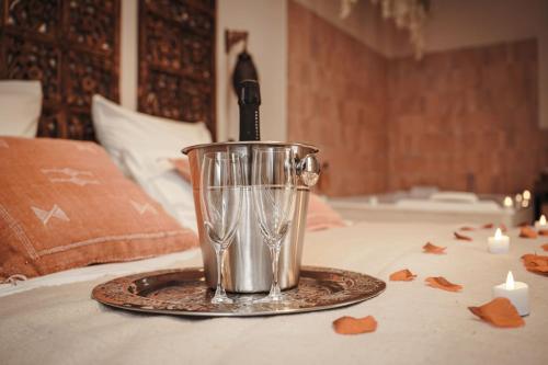 a wine glass sitting on top of a table at La Cour Secrète - Riad & Balnéo privée in Carpentras