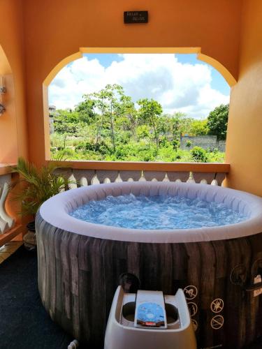 a large wooden tub in a room with a window at Destiny Seaside in Content