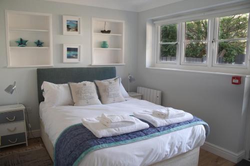a bedroom with a bed with towels on it at Palomar in Falmouth
