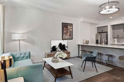 a living room with a couch and chairs and a table at Contemporary Condo Downtown Savannah in Savannah