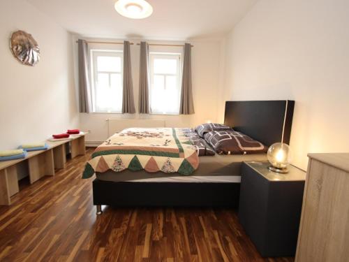 a bedroom with a bed and some benches at Ferienwohnung in Elbingerode by Belvilla in Elbingerode