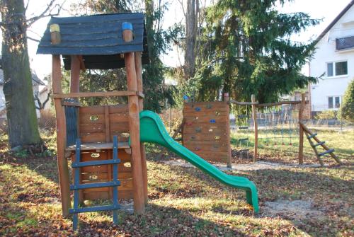 a playground with a chair and a slide at Privát Voyage in Liptovský Mikuláš