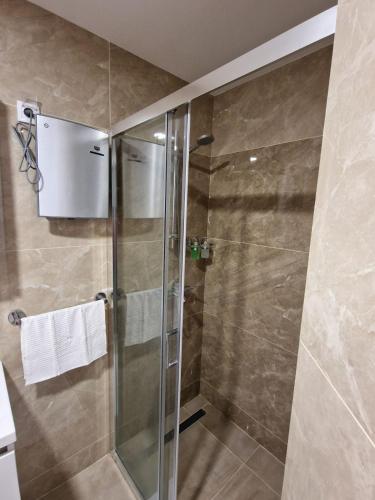 a shower with a glass door in a bathroom at Altura Garden 1 in Vrnjačka Banja