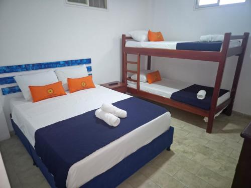 a bedroom with two beds and a bunk bed at Hotel Girasol in Santa Rosa de Cabal